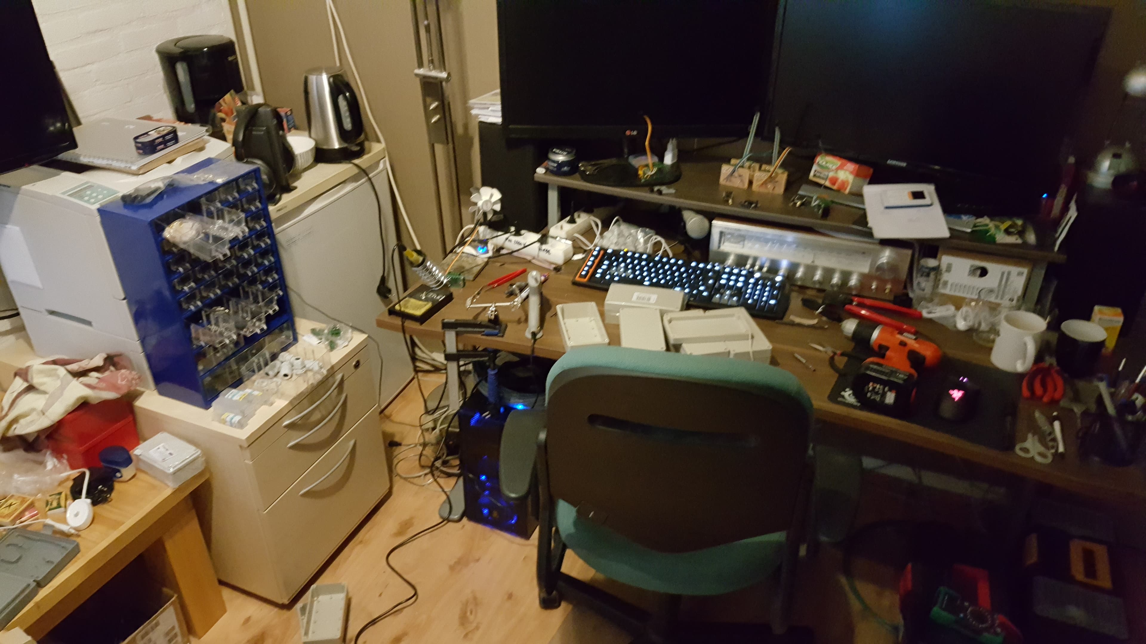 Home electronics workshop with soldering equipment, enclosures, and tools used to build the prototypes